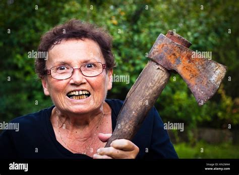 Crazy Senior Woman Holding Axe Stock Photo Alamy