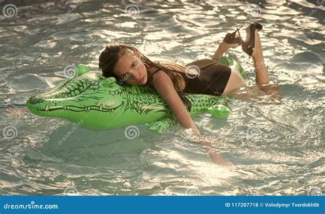 Girl On Inflatable Mattress Crocodile In The Pool Stock Photo Image