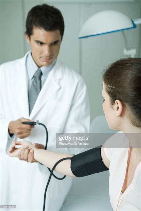 Doctor Taking Womans Blood Pressure High Res Stock Photo Getty Images