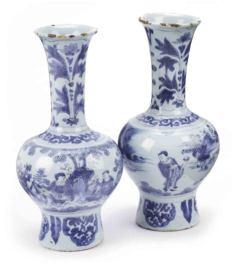 A Pair Of Dutch Delft Blue And White Chinoiserie Bottle Vases Circa