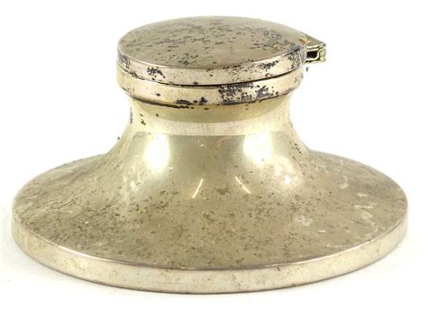 A George V Silver Capstan Inkwell With A Hinged Lid The Circular Base