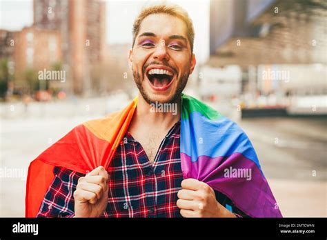 Gay Man With Makeup On Having Fun Wearing Lgbt Rainbow Flag Outdoor Main Focus On Mouth Stock