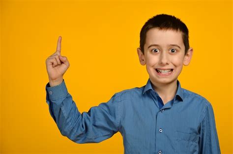 Premium Photo Little Boy In Blue Shirt Makes Funny Face
