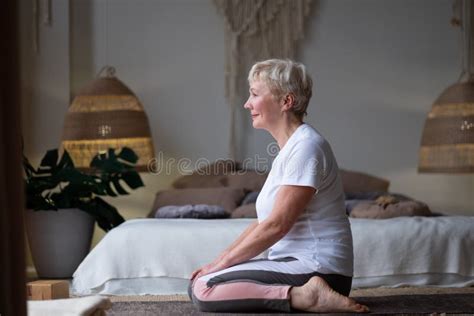 Woman Doing Yoga Exercise On Mat In Virasana Or Hero Pose With Reversed