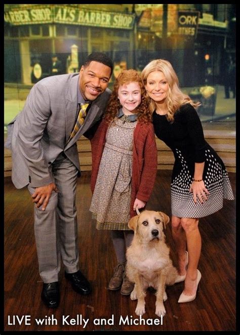 A Man And Two Women Pose With A Dog On The Set Of Tv Talk Show Live