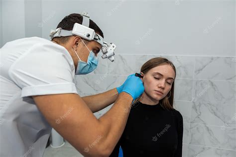 Premium Photo Ent Doctor Uses An Otoscope To Examine A Patients Ear