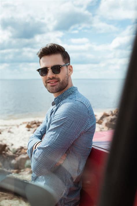 Handsome Smiling Man Standing At Car Near The Sea During Stock Image