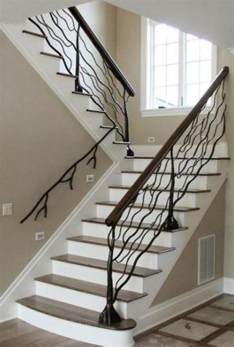 This airy, contemporary entrance is lit by several chic wall sconces and features a dark brown wood floor and floating stairs. Custom Metal Handrail Designs For Staircases / design ...