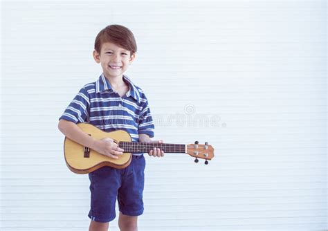 A Little Boy Is Playing Guitar Stock Image Image Of Melody Equipment