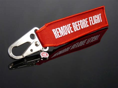 Remove before flight is a safety warning often seen on removable aircraft and spacecraft components, typically in the form of a red ribbon, to indicate that a device, such as a protective cover or a pin to prevent the movement of mechanical parts, is only used when the aircraft is on the ground. Schlüsselanhänger Schnabel-Karabiner " REMOVE BEFORE ...