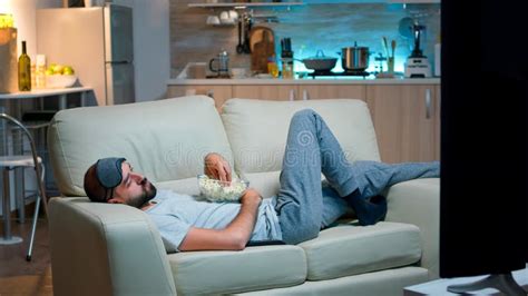 Man Lying On Sofa Falling Asleep In Fron Of The TV Stock Photo Image Of Evening Relax