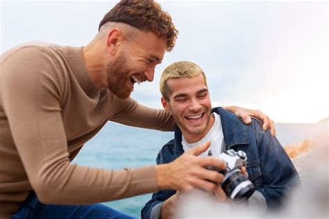 free photo gay couple on the beach with camera