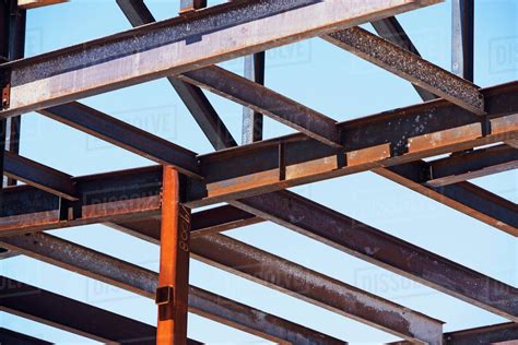 Low angle view of steel beams at construction site - Stock Photo - Dissolve