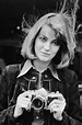 Lynne Frederick posing while holding a camera, 1977. – Bygonely