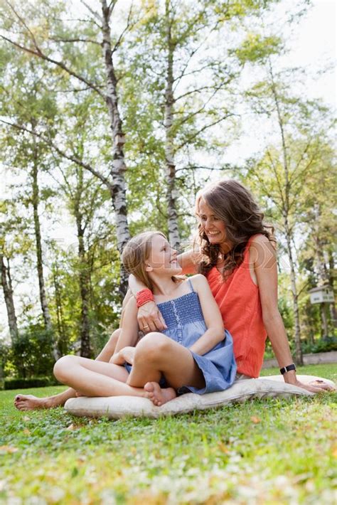 mother and daughter sitting in garden stock image colourbox