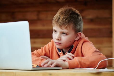 Premium Photo Portrait Of A Child Boy With A Smart Focused Face Doing