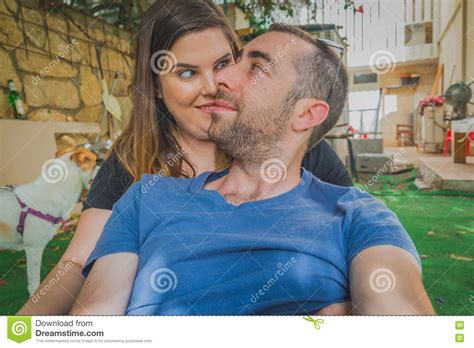 Young Couple Enjoying Together In The Backyard They Are Smiling