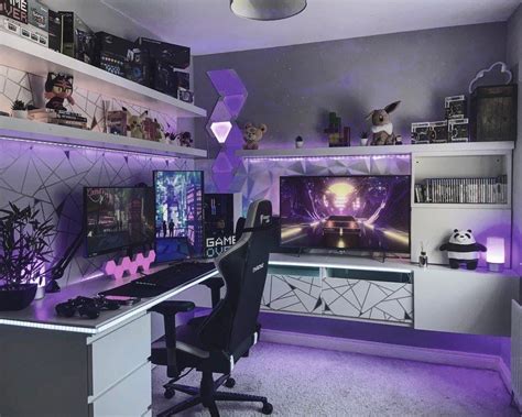 A Computer Desk With Two Monitors On It And Purple Lighting In The Room