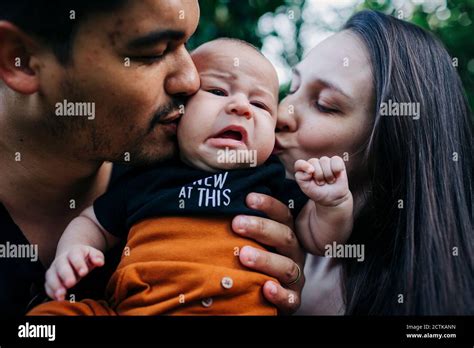 Young Parents Kissing Cute Baby Boy Stock Photo Alamy