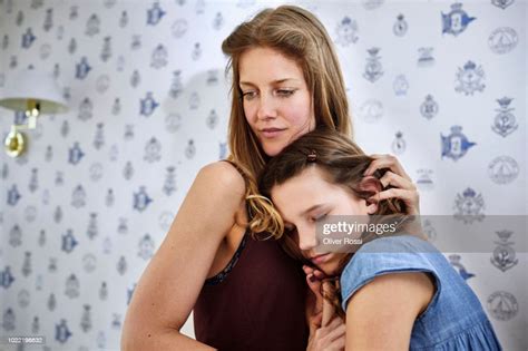 Mother Hugging Serious Daughter Photo Getty Images