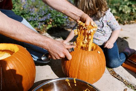 Children Carving Pumpkin Outdoors By Stocksy Contributor Serena