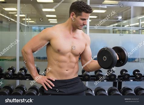 Shirtless Bodybuilder Lifting Heavy Black Dumbbell Stock Photo