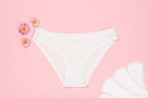 premium photo beautiful white panties with sanitary napkins on pink background women