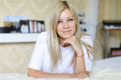 Charming Blonde Smiles And Poses For Camera Located In Sleeping Stock