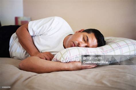 Man Sleeping Peacefully On His Bed High Res Stock Photo Getty Images