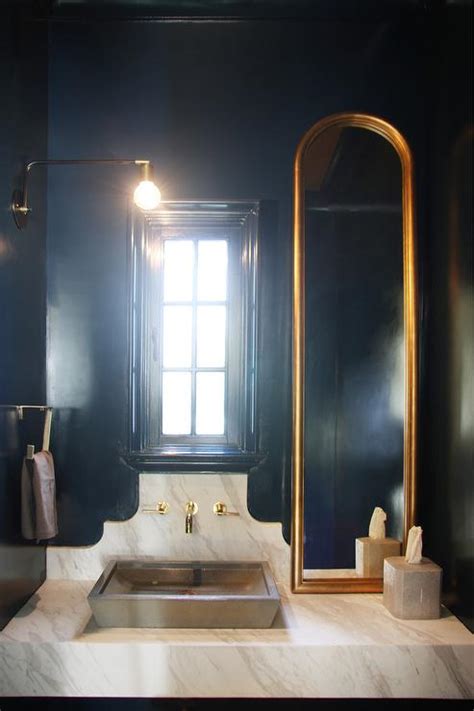 black  gold powder room  wood sink vanity