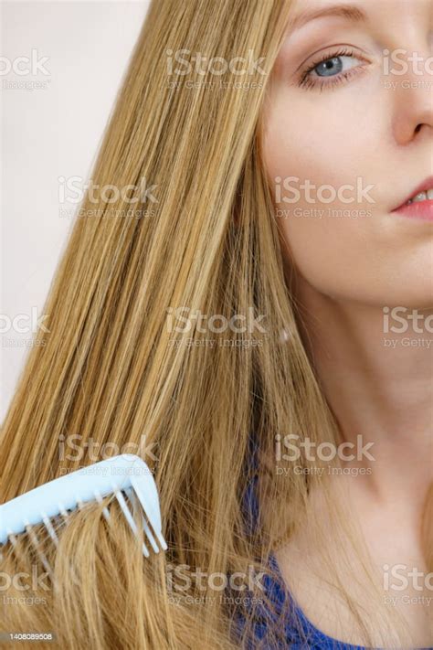 Woman Combing Long Healthy Blonde Hair Stock Photo Download Image Now