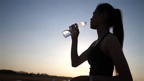 Woman Holding Bottle Up To Drink Water After Exercise 1627063 Stock