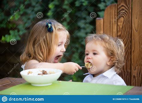 Little Funny Girl Sister Feeding Baby Cute Funny Babies Eating Baby