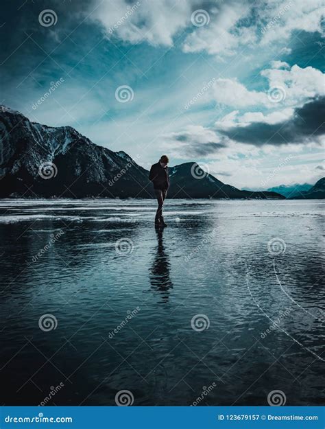 Man Walks Across A Frozen Lake Stock Image Image Of Alberta Lake