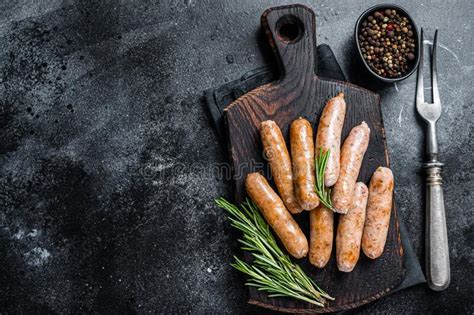 Fried Bratwurst Or Hot Dogs Sausages On A Wooden Board Black