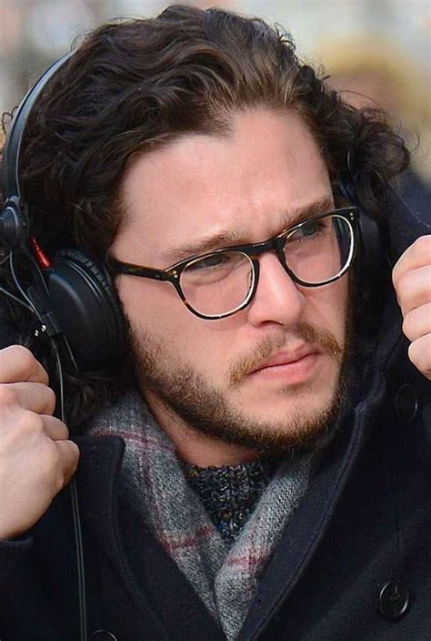 A Man Wearing Glasses And Headphones On The Street