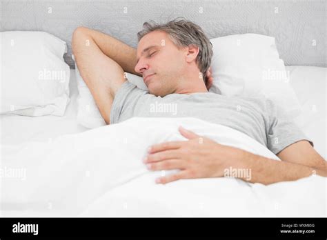 Man Sleeping Soundly In His Bed At Home Stock Photo Alamy