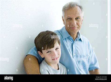 Grandfather And Grandson Smiling At Camera Together Portrait Stock