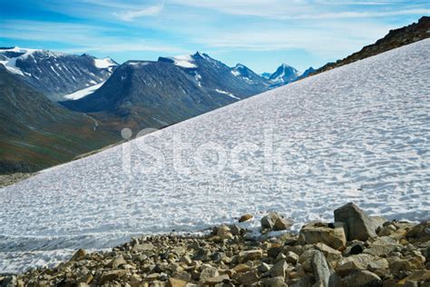 Snow Field And Mountain Range In Jotunheimen National Park Stock Photo