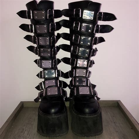 Goth platform boots and mega platforms for men and women by demonia and new rock in leather and vegan leather, featuring buckles, skulls, spikes, straps and corset lacing. 🖤 Demonia trinity boots 🖤 Damned 318 SOLD OUT... - Depop