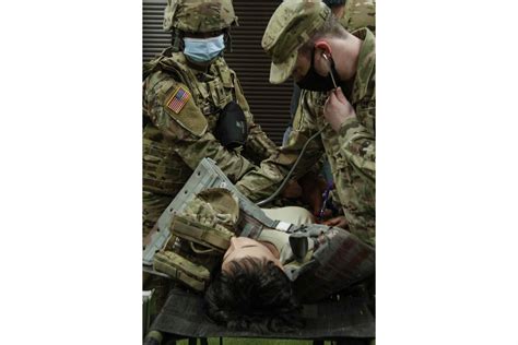 Army Combat Medics Evaluate Lifelike Female Trauma Mannequin