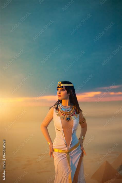 egypt style rich luxury woman sexy beautiful girl goddess queen cleopatra stands yellow sand
