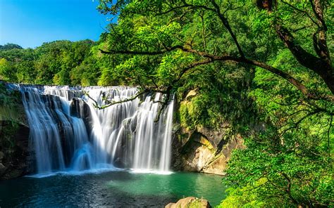 Waterfalls From Green Algae Covered Rock Pouring On Lake Stones In