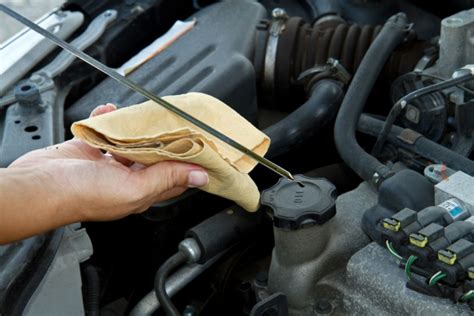 Pull it out and immediately wipe it off because there is going to be oil splashed up on the stick from the engine running. Beginner's Guide on How to Check Your Oil | Gold Eagle Co
