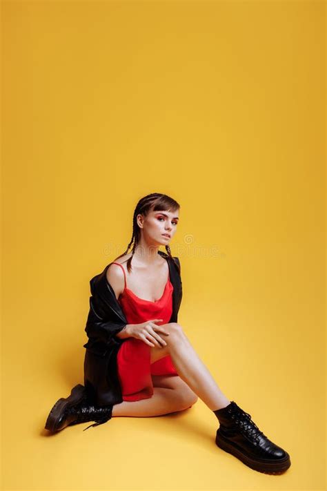 Beautiful Female Model In A Red Dress Yellow Background Stock Photo