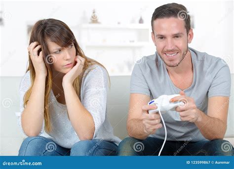 Annoyed Girlfriend Waiting For Boyfriend To Stop Playing Video Games