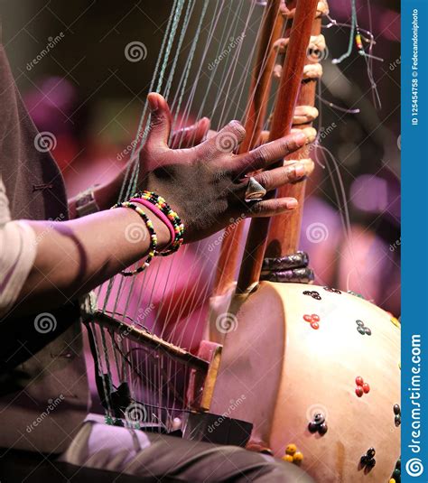 Young African Boy Plays A Stringed Instrument Stock Photo Image Of