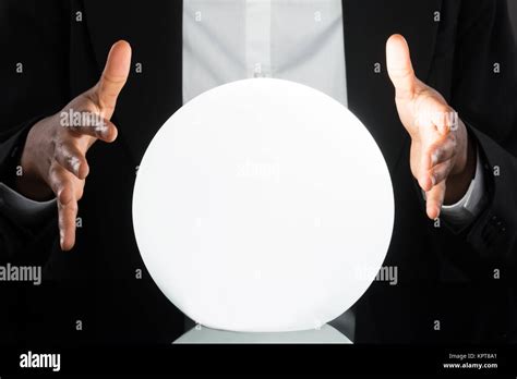 Businessperson Predicting Future With Crystal Ball Stock Photo - Alamy