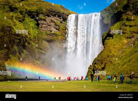Iceland Skogafoss Waterfall With Double Rainbow And Tourist Admiring