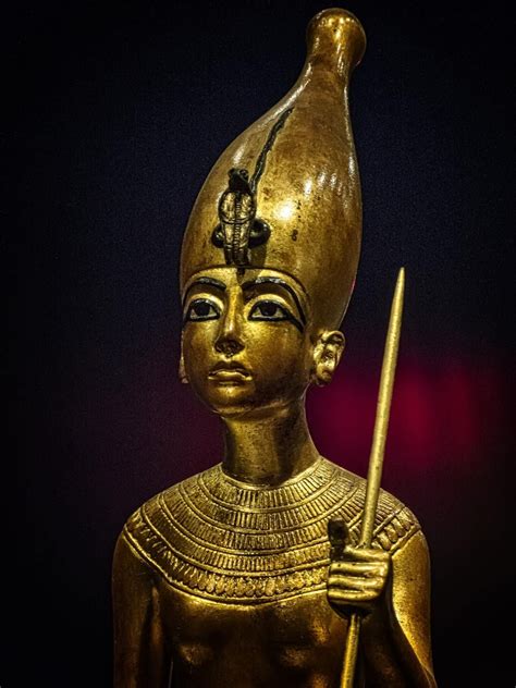 Closeup Of Gold Figurine Of King Tutankhamun Standing On The Back Of A